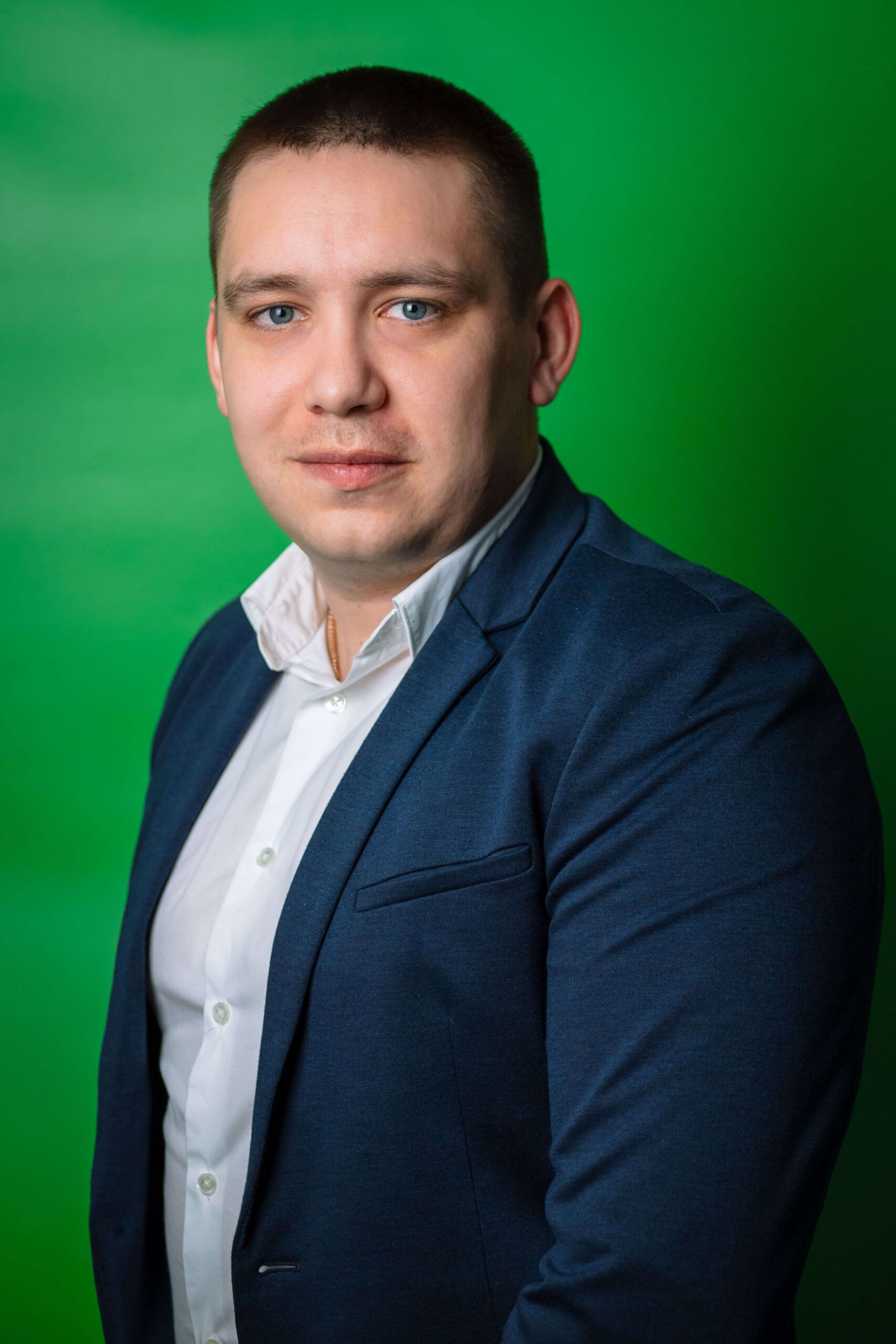 Portrait of the manager of Express Heroes, Mr. I. Terikhov, wearing a black suit and white shirt, standing in front of a green background.